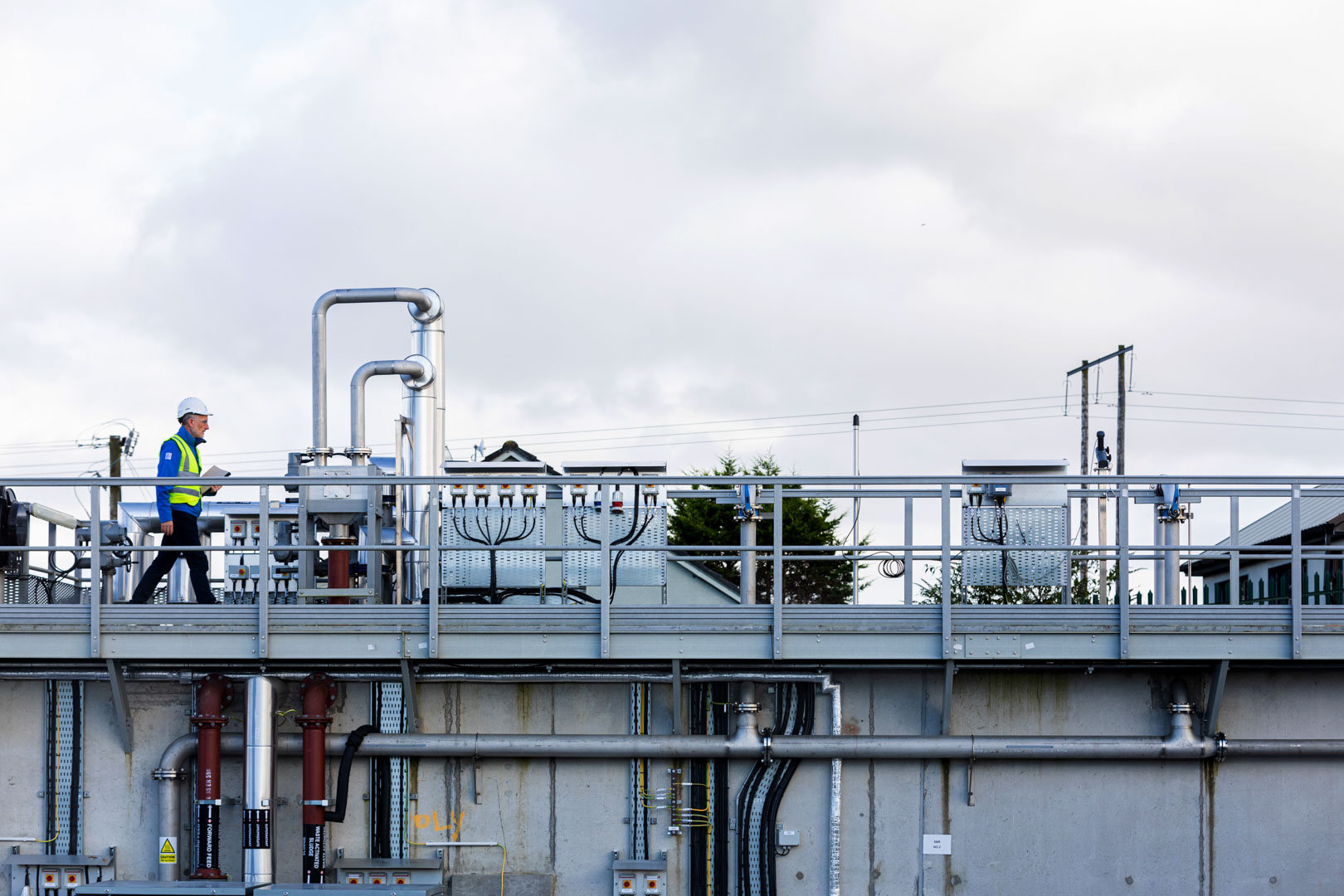 An Uisce Éireann worker walking in a water treatment plant in Collooney