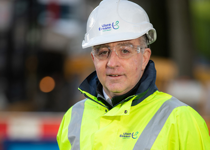 Uisce Éireann worker in helmet, hi-vis jacket and protective glasses