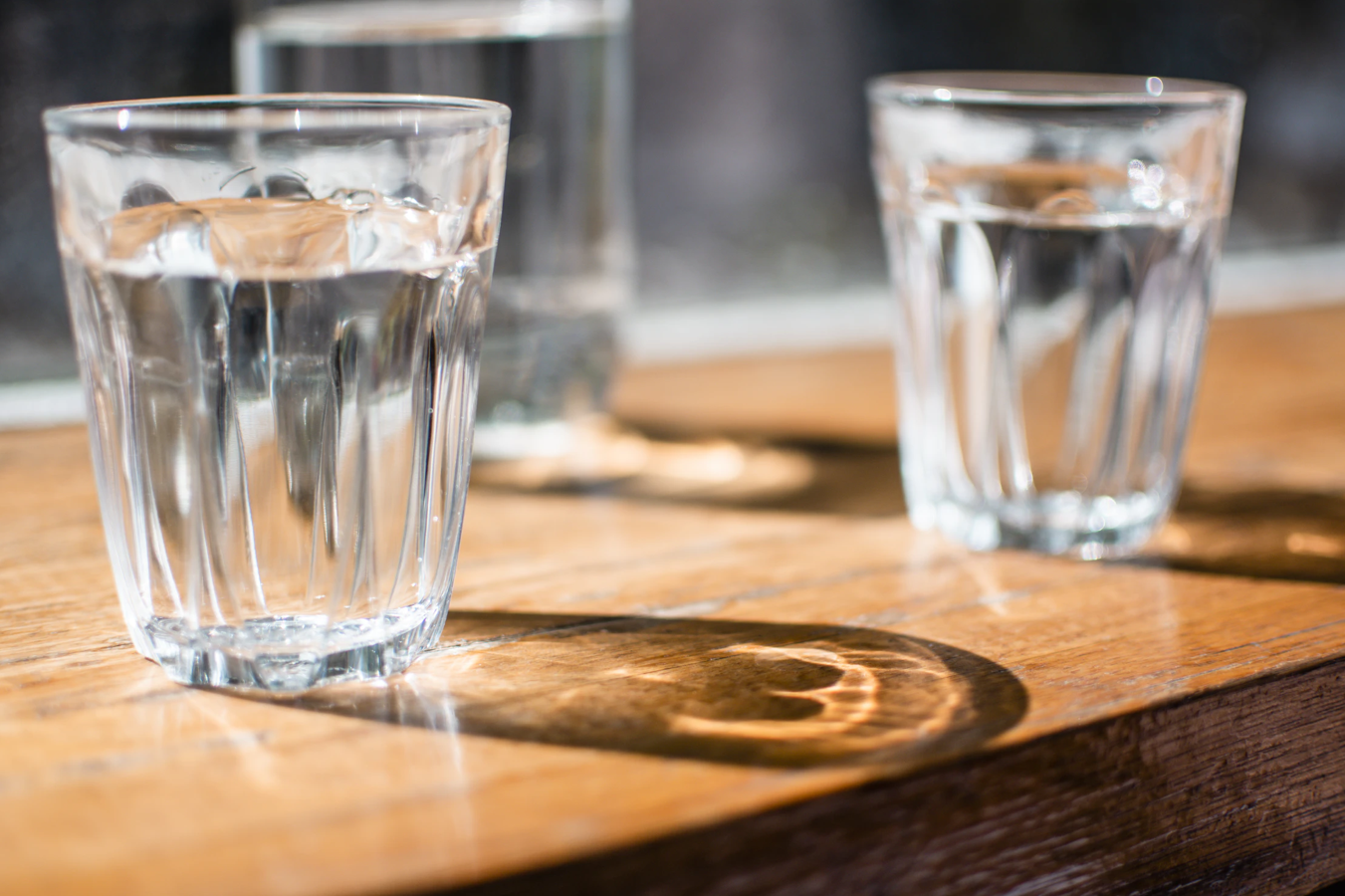 Three glasses of water on a table