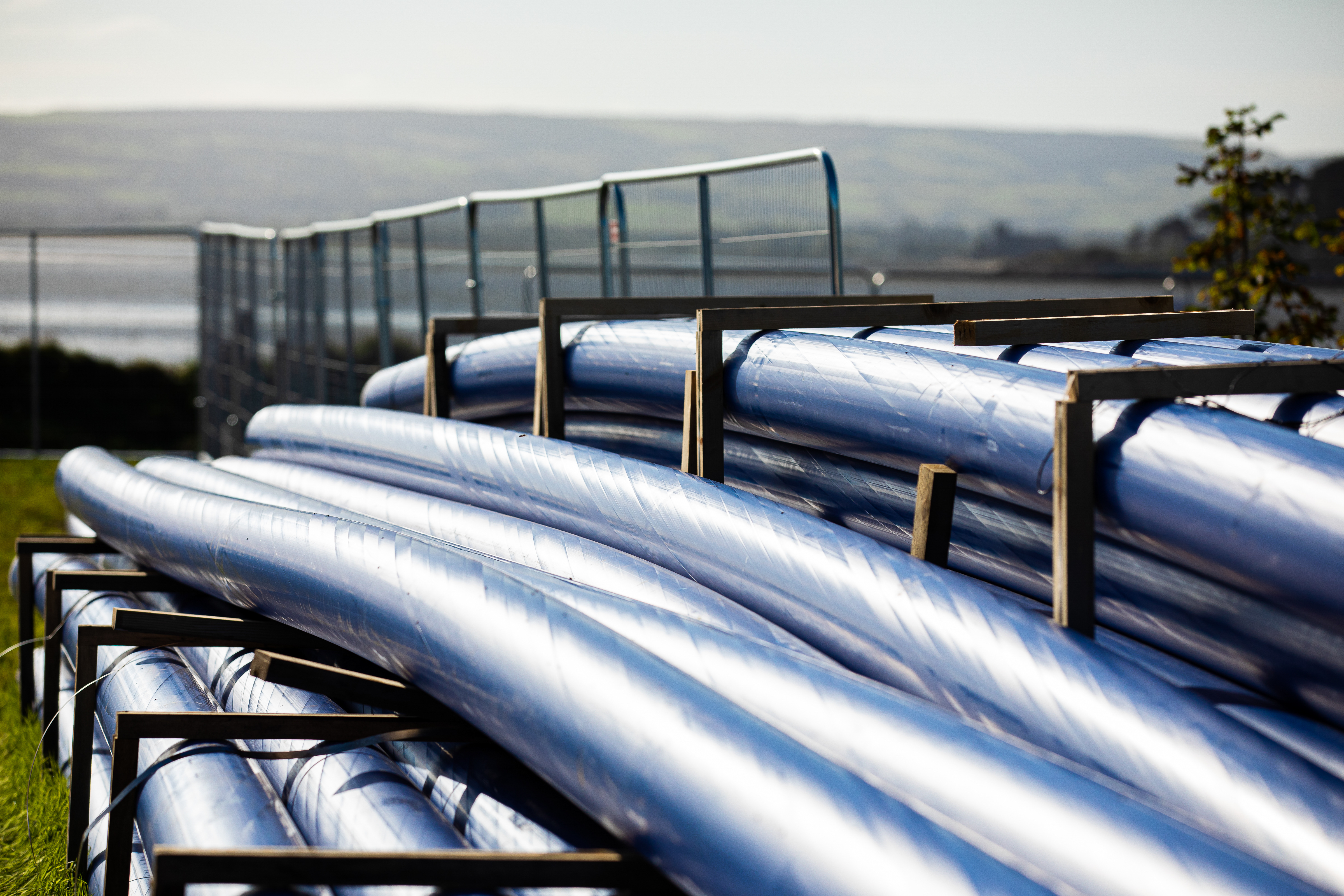 A pile of blue pipes in the countryside