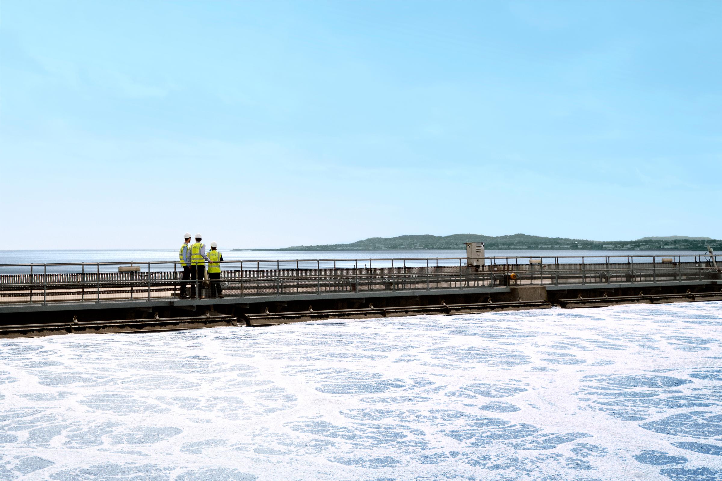 Uisce Éireann workers on a platform in the sea