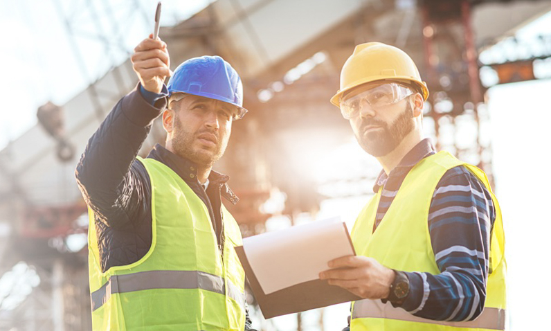 two Uisce Éireann workers pointing at something on site 