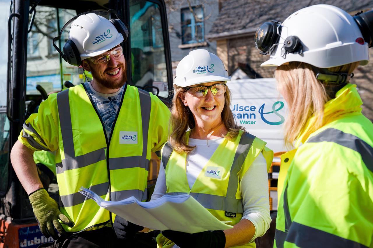 Three Uisce Éireann workers talking at a site