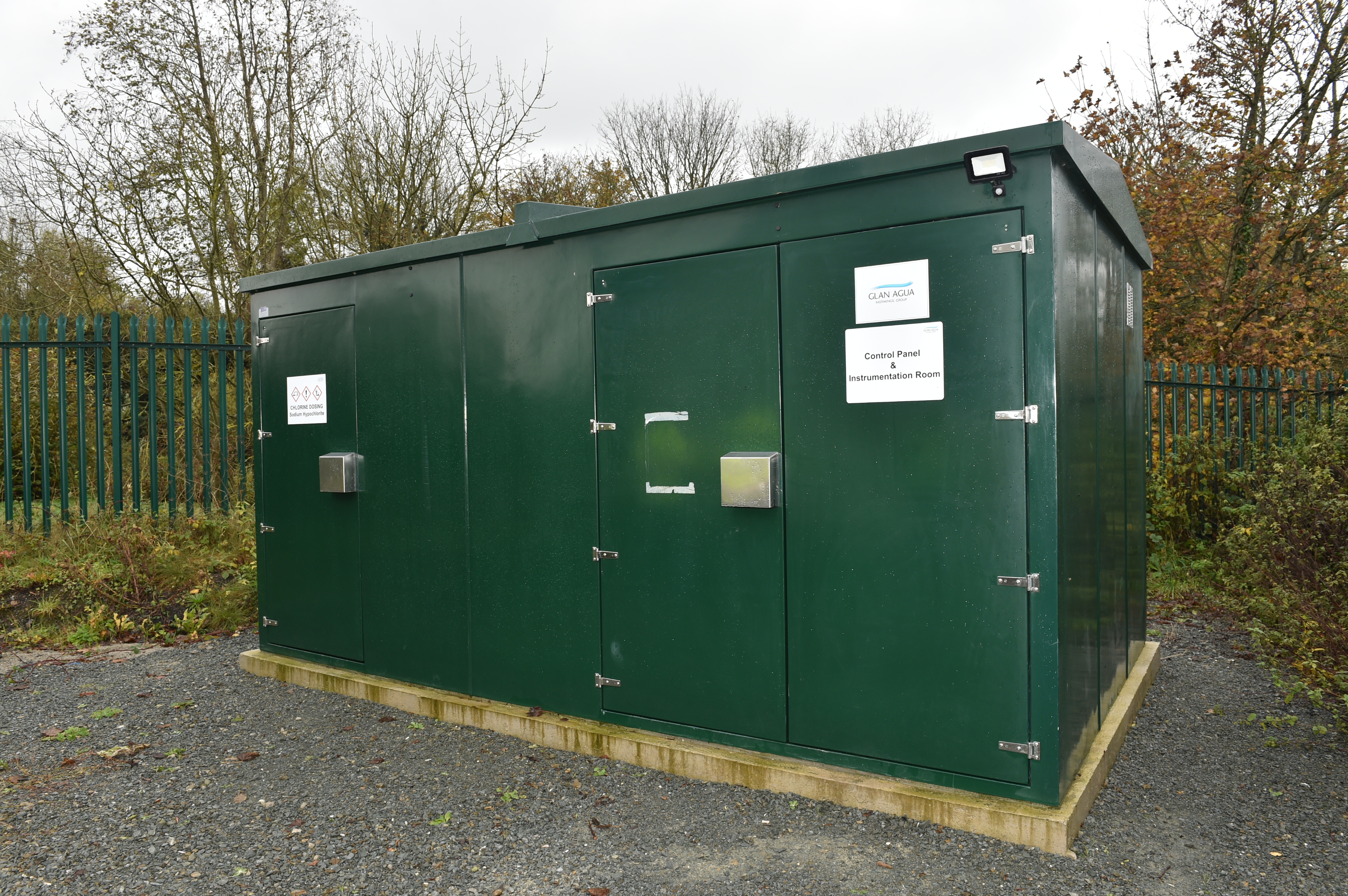 A rectangular green metal building 