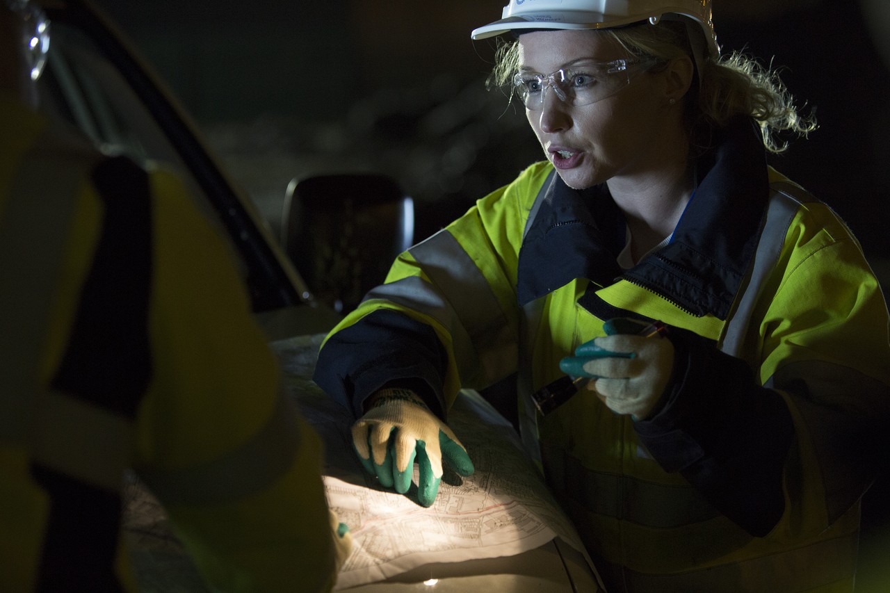 An engineer pointing at a map