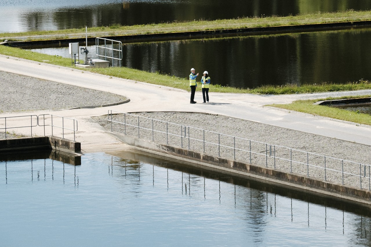 Two Uisce Éireann workers talking in a water treatment plant