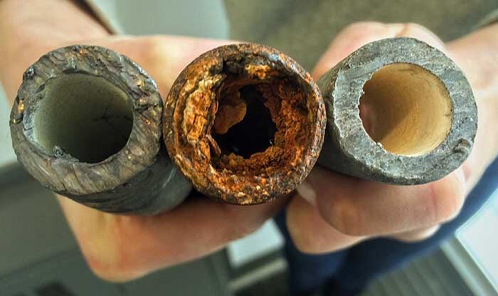 Three pipes of various states of disarray cut in half 