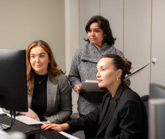 Three ladies looking into the computer