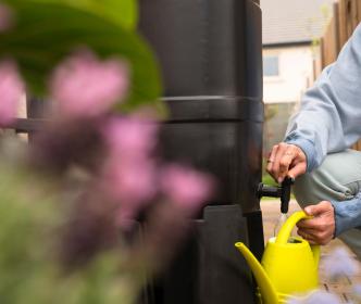 A man filling a watering can